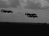 Three large military aircraft fly in formation against a cloudy sky, recalling iconic moments from the British war film "The Dam Busters (1955)"—now available on DVD.