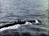 A dark submarine glides through the ocean, its conning tower emerging above water—just like scenes from World War II films such as Submarine X-1 (1968) DVD.