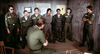 Seven soldiers in uniform line up before an officer in a dim, map-filled room—a striking scene from the Vietnam War film, Go Tell the Spartans (1978) DVD.