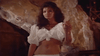 A woman with long dark hair stands indoors, dressed in a white off-the-shoulder outfit, evoking the dramatic mood of a classic pirate film—reminiscent of "Morgan The Pirate DVD (1960)" set in Panama.
