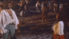 A man and woman in old-fashioned white shirts stand face to face on a beach at night, surrounded by a similarly dressed crowd and a campfire—evoking scenes from the Morgan The Pirate DVD (1960).