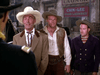 Three men in Old West attire stand outdoors before a "Chin-Lee Hand Laundry" sign. The Man Behind the Gun (1953) DVD is perfect for fans seeking rare, hard-to-find classic movies and authentic vintage scenes.