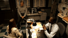 Two men, one in a sheriff’s uniform and one in a suit, talk to a seated woman across a desk in an office filled with files. The scene is from the Everything She Ever Wanted (2009) DVD.