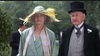 A woman in a pale green dress and feathered hat stands beside a man in a black suit and top hat at an outdoor formal event, evoking 1923 London as seen in the film adaptation Mrs. Dalloway (1997) DVD.