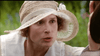 A woman in a wide-brimmed straw hat with a ribbon and flower leans forward, her style echoing 1923 London as seen in the Mrs. Dalloway (1997) DVD, evoking the atmosphere of Virginia Woolf’s timeless world.
