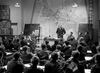 A group of military officers attends a WWII briefing in front of a large map of Europe—a classic scene from "Raiders in the Sky (1953)" now available on DVD.