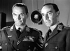 Two men in military uniforms, medals shining, stand side by side in a tense scene from "Raiders in the Sky (1953)" DVD—a gripping black-and-white WWII drama that's perfect for classic film collectors.