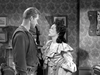 A black-and-white still from The Broken Star (1956) DVD shows a man in western attire and a woman in a ruffled dress facing each other in a vintage room, evoking the tense drama of classic films.