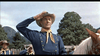 A man in a blue uniform and cowboy hat salutes by a horse with mountains behind him, evoking classic scenes from the "7th Cavalry (1956) DVD." Other men in uniform stand in the background.