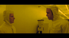 Two people in yellow protective suits face each other in a yellow-lit lab, with equipment in the background—evoking the suspenseful atmosphere of Runaway (1984) DVD.