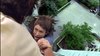 A woman dangles from a tall building, clinging to a man's hand, her terrified face above the city—capturing suspense like in Murder Most Likely (1999) on DVD.
