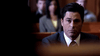 A man in a suit sits seriously in a courtroom—a striking moment from the true crime drama "Too Late To Say Goodbye (2009) DVD." Other people are visible in the background, slightly out of focus.
