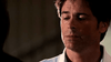 A man with short brown hair and a serious look wears a white collared shirt, set against a dim, unfocused background evocative of true crime dramas like Rob Lowe’s Too Late To Say Goodbye (2009) DVD.