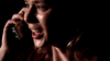 A woman with tears in her eyes urgently talks on a cellphone in the dark, her face illuminated with intense emotion, depicted on the Too Late To Say Goodbye (2009) DVD—a gripping true crime drama.