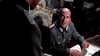 A man in a World War II-era German uniform sits at an ornate desk, looking up at another—evoking the intense scenes featured in rare films like "Attack on the Iron Coast (1968) DVD.
