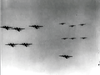 Black and white photo of military airplanes flying in formation against clouds, evoking scenes from rare classic wartime movies like "The Green Devils of Monte Cassino (1958)" now available on DVD.