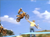 The DVD "Crossing the Line (1990)" features a motocross rider mid-air on a dirt bike jumping over someone with an object, with another rider visible in the background under a blue, cloudy sky.
