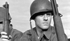 A black-and-white photo of a young soldier with helmet and rifle, gazing into the distance, captures the emotion found in vintage classics like War Hunt (1962) DVD or any intense Korean War film.