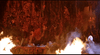 A fiery scene reminiscent of "Deconstructing Harry (1997) DVD" features flames in the foreground and twisted human figures embedded in a rocky, reddish wall, creating a nightmarish, inferno-like atmosphere.