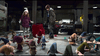 Two children in winter clothes stand in a workshop, facing colorful, gnome-like creatures with hats—a lively scene straight out of a holiday movie like The Christmas Chronicles (2018) DVD.