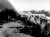 Black-and-white photo capturing WWII soldiers landing from ships, invoking the dramatic scenes featured in vintage classics like Submarine Command (1951) DVD, with troops wading ashore and landing craft in the background.
