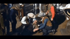 A group of cowboys in hats assist someone lying on the ground as others watch, evoking a classic Spaghetti Western scene from Three Graves for a Winchester (1966), available now on DVD.