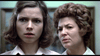 Two women stand close indoors, both with serious, concerned expressions—reminiscent of a tense scene from the Dead of Night (1974) DVD.