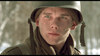 A young soldier in winter gear stands in the snowy Ardennes forest, evoking the tense WWII atmosphere of "A Midnight Clear (1992)"—now available on DVD.