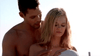 A shirtless man stands behind a blonde woman as she looks down thoughtfully at a volleyball, both focused in bright sunlight—echoing the suspenseful atmosphere of Blue-eyed Butcher (2012) DVD.