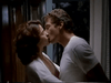 A man and woman share a passionate kiss indoors, echoing classic romance scenes like those in the "Tall Dark and Deadly DVD (1995)." The man wears a white t-shirt and the woman a white top.