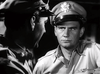 Two men in military uniforms face each other indoors—one seen from behind, the other with a serious look. This black-and-white moment captures the intensity found in The Wild Blue Yonder (1951) DVD.