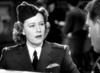 A uniformed woman with tie and cap appears attentive as she speaks to a man in this black-and-white scene from "A Guy Named Joe (1943) DVD," a classic film now available.