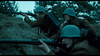 Three soldiers in green helmets and brown uniforms crouch in a trench, rifles ready, against pine trees and a cloudy sky—capturing the tense World War II atmosphere seen in the film "April 9th (2015) DVD.
