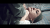 A woman with a headscarf and earrings lies on patterned bedding, a look of distress on her face as someone grips her neck—capturing the chilling intensity of "The House That Jack Built (2018)" DVD.