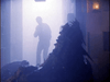 A shadowy figure stands in a misty hallway as a spiky creature looms—evoking the chilling sci-fi horror atmosphere of Dead Space (1991), now available on DVD.