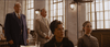Four people in vintage attire are inside a sunlit courtroom, evoking classic film drama. The formal, tense scene recalls the atmosphere of "The Pardon (2013)" DVD.