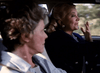 Two older women sit in a car, one driving and holding a cigarette while talking to the other. With blurred greenery outside, this scene is featured in the "Best Friends for Life (1998) DVD," ideal for classic movie fans.