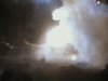 A massive explosion with bright flames and dense smoke fills the dark night, echoing intense scenes from "Hell on the Battleground (1988) DVD," a classic Vietnam War action drama.