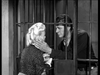 In this black-and-white scene from the classic Western "A Noose for a Gunman (1960) DVD," a man behind jail bars gently holds a blonde woman's face through the cell bars, both displaying deep emotion.