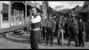 A man in a vest stands with a rifle on a dusty Western street as others watch in this striking black-and-white scene from the 1958 classic "Terror in a Texas Town" on DVD.