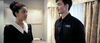 A woman in a black-and-white uniform faces a man named Tom in a room with floral curtains and artwork, capturing the eerie vibe of an anthology horror film, as seen in the "Haunted Hotel (2021) DVD.