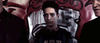 A young person with short hair and headphones around their neck stands before a graffiti wall, shadows obscuring their dark shirt and creating a supernatural mood. Two adults are partly visible nearby. Featured: Haunted Hotel (2021) DVD.