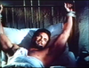 Steve Reeves is a bearded man lying on a bed with his wrists tied to the headboard in The White Warrior (1959) DVD.