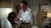 In a warmly lit room, a man in a white shirt gently holds a woman’s head with concern—a scene reminiscent of classic moments found in rare, hard-to-find movies like the "Bogie (1980) DVD.