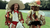Two people in vibrant 17th-century costumes, evoking Alexandre Dumas’s style, stand near water and trees—reflecting a scene from The Man in the Iron Mask (1977) DVD.