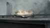 A blazing shark crashes onto a city rooftop with skyscrapers and smoky skies in the chaos of Sharknado 2: The Second One (2014) DVD, as a person and debris tumble in the background, adding dramatic cinematic flair.