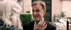 A man in a suit smiles warmly at an older woman with white hair and red nails, her hand raised as they chat outdoors—perhaps discussing their favorite true crime DVD, Georgetown (2019).