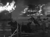 A horse-drawn wagon rushes past burning buildings at night in a thrilling scene from The Westerner (1940) DVD, a classic Western adventure.