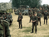 A group of WWII-era soldiers stand outdoors by a truck, motorcycles, and a jeep—evoking scenes from classic war films. Product: Come and See (1995) DVD.