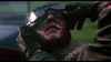 A person in aviator gear lies injured as another supports them—a dramatic scene from World War I, captured in the film "Von Richthoften vs Brown (1971)" DVD.